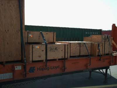 packing crates stacked and strapped down along a shipping container